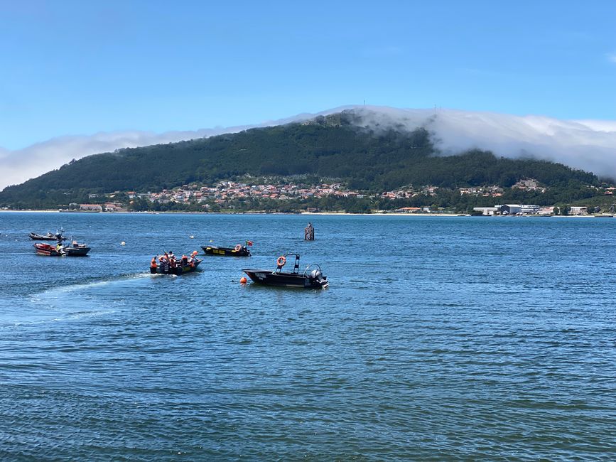 Here a boat crosses the Rio Mino with pilgrims heading to Spain