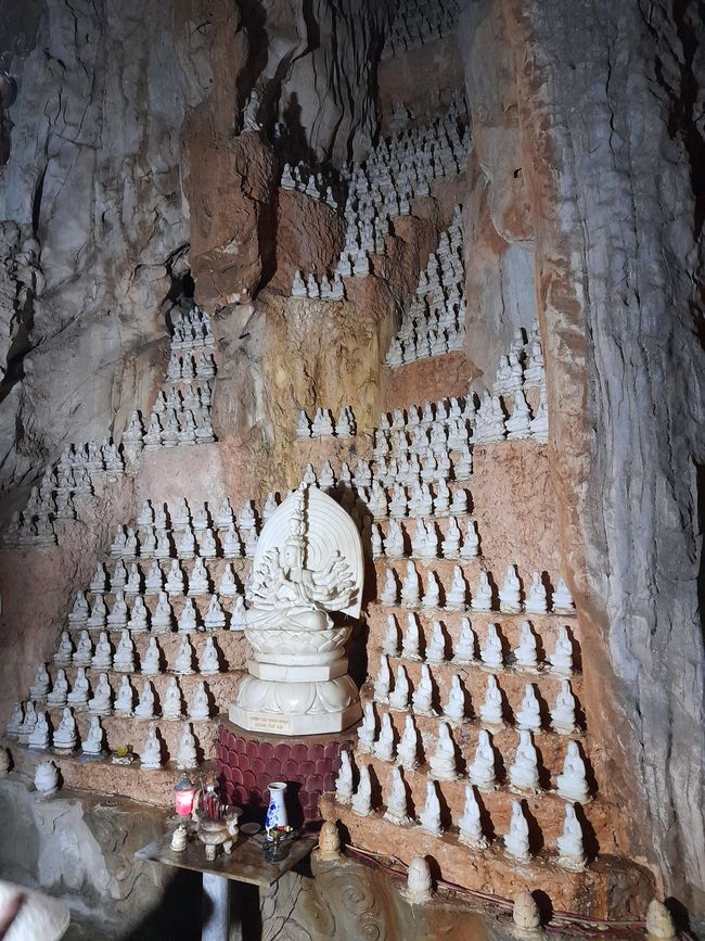 Many marble Buddhas in a cave