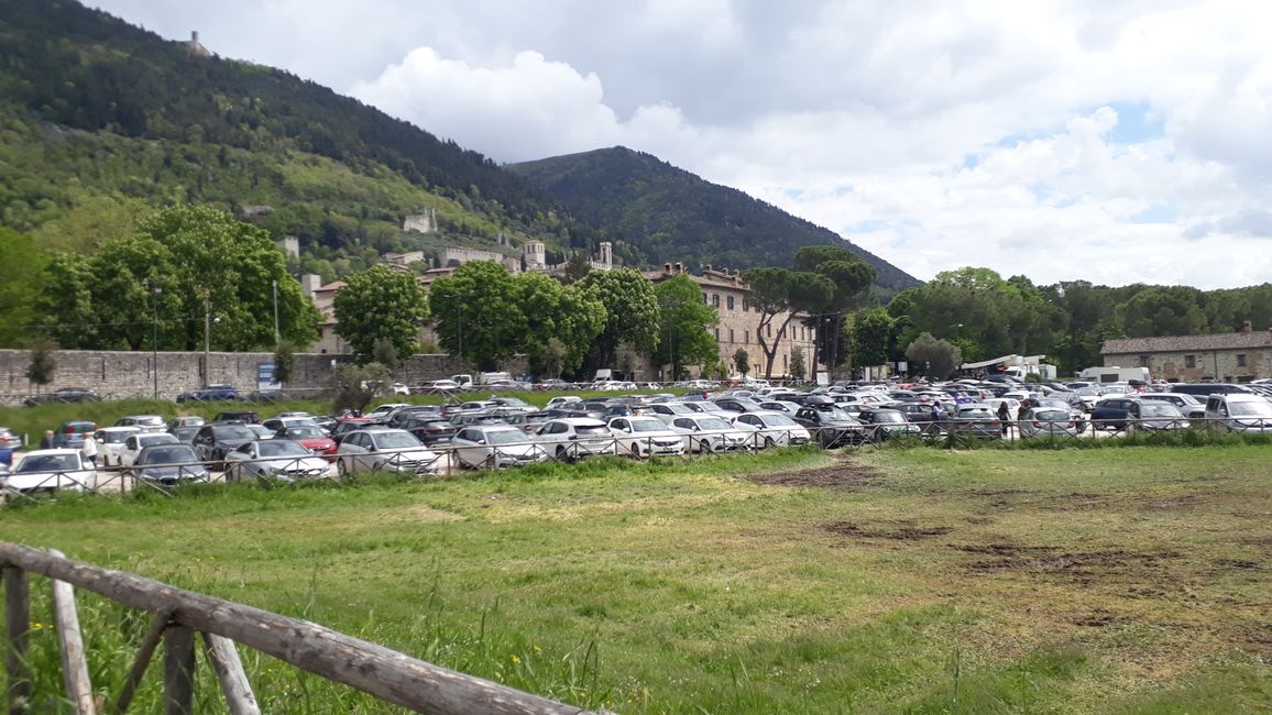The contrast: parking lot with cars at the foot of Gubbio