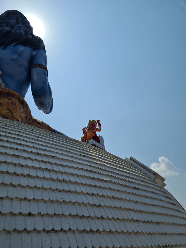 The small Ganesha statue circling the Shiva statue.
