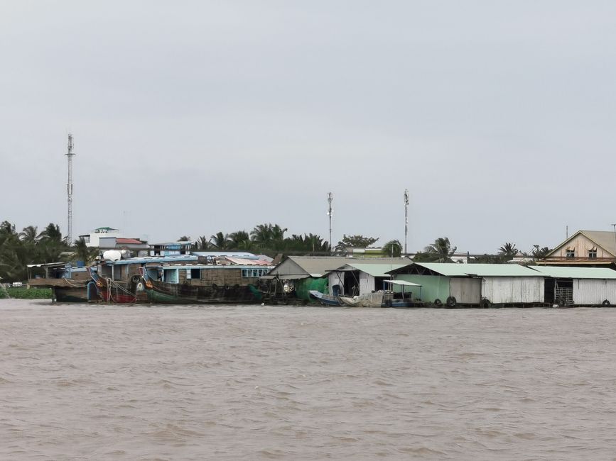 ... past floating fishing huts and ...