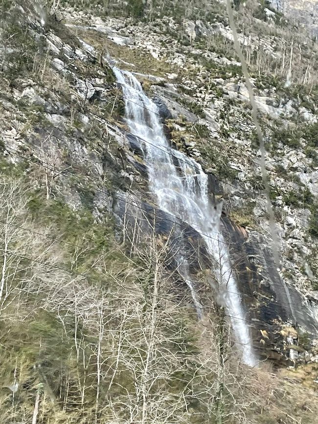 A waterfall rushes down the mountain.