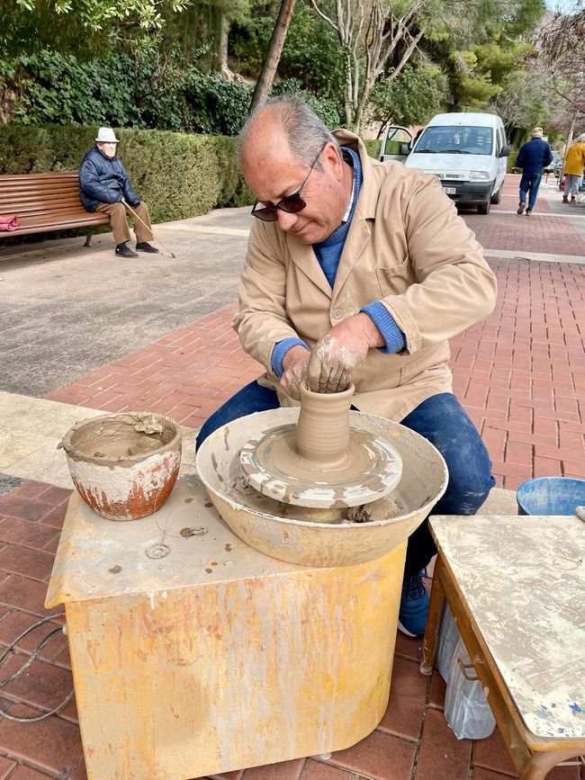 A potter on the market in front of the church.