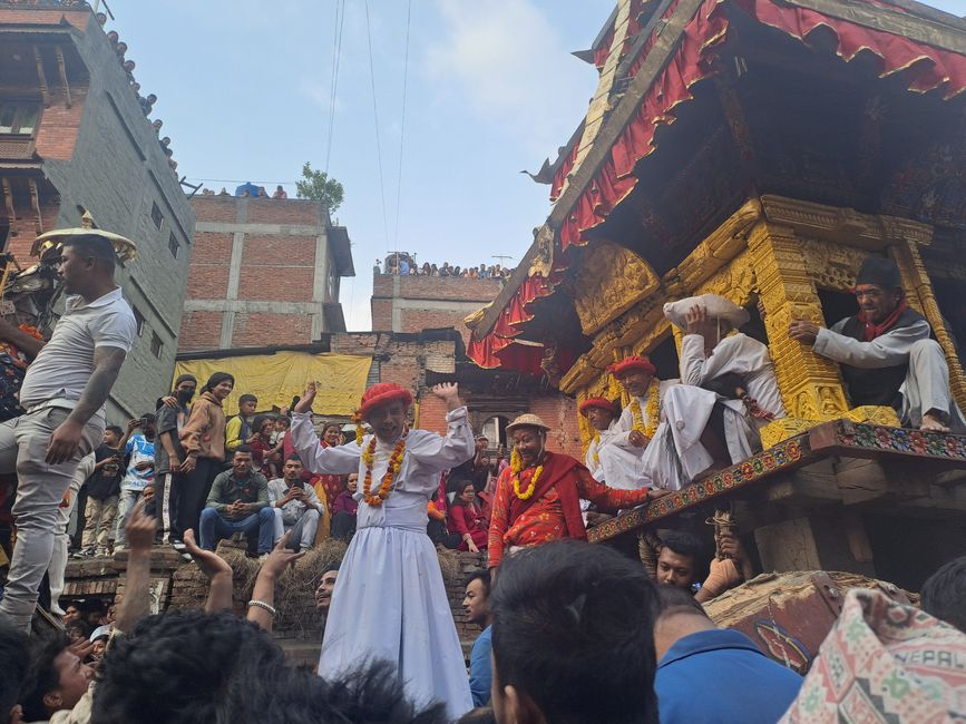 The "temple on wheels" is pulled away from the square through the crowd.