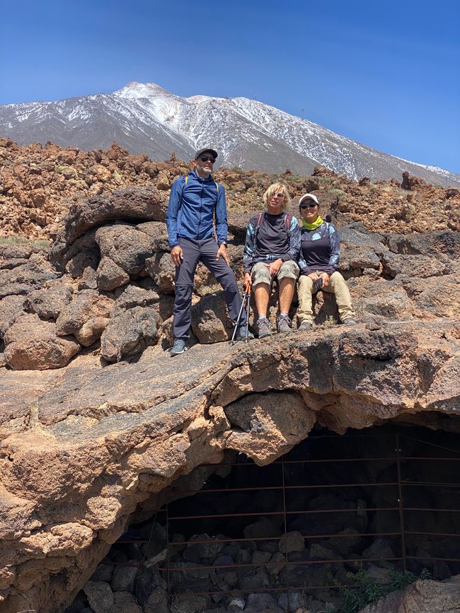 Hiking with friends in Teide National Park in front of the snow-capped peak