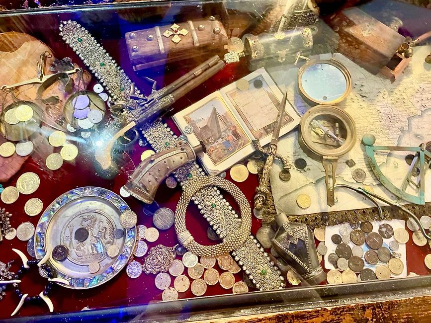 A table with its valuable contents under a glass top.