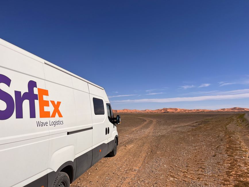 Behind the rocky desert, the dune sea of Erg Chebbi emerges...