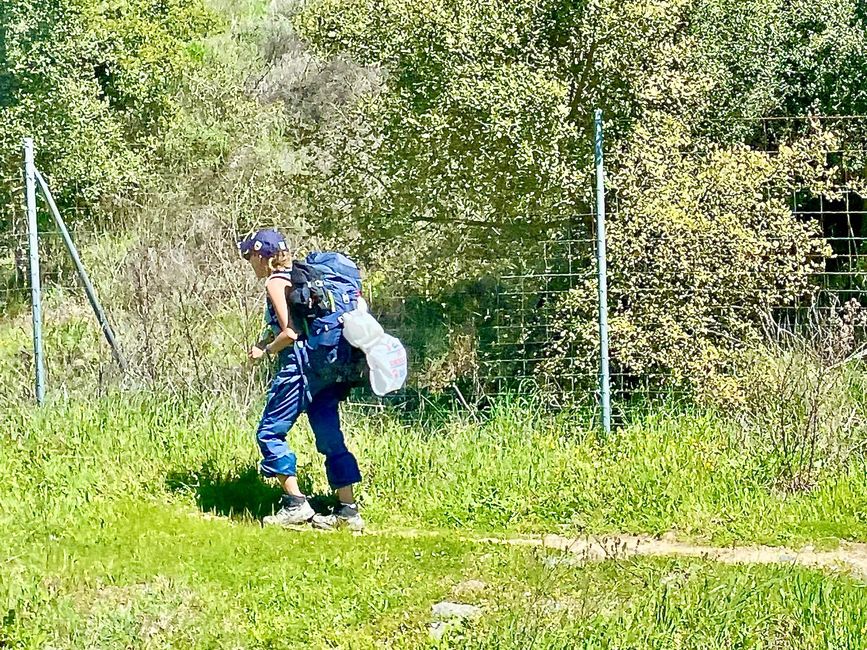 On the pilgrimage route Camino de Santiago. This woman seems to be carrying a heavy load ...