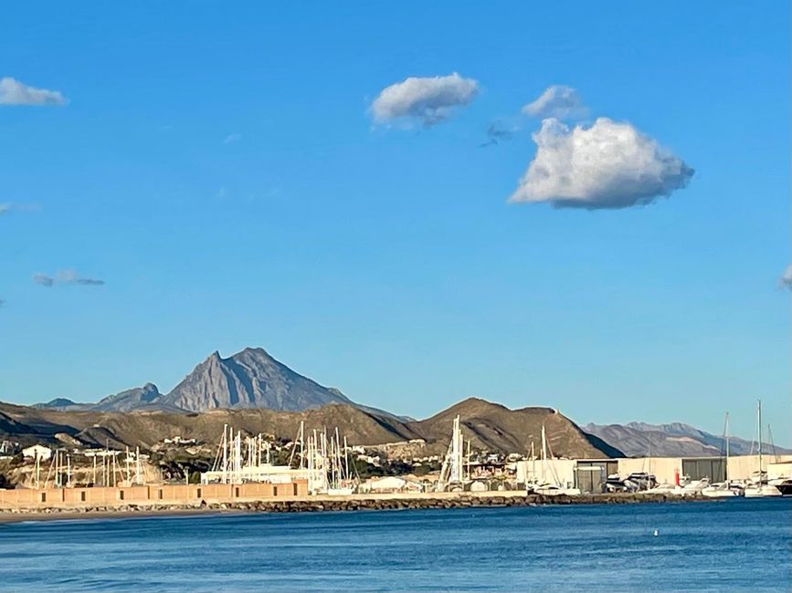 A mountain range behind the silhouette of El Campello.