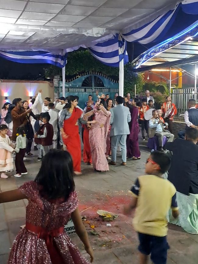 Some guests dance during the wedding ceremony. The chapel can be seen on the right side of the picture.