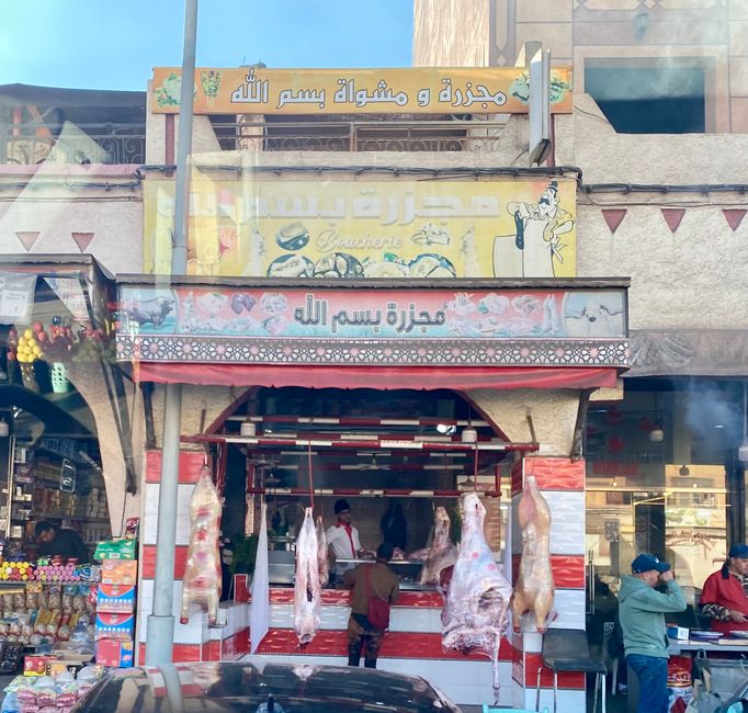 Butcher shops are always red and white striped with meat displayed outdoors