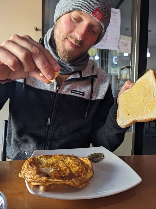 Dorian is eating his first whitebait sandwich (a NZ delicacy)
