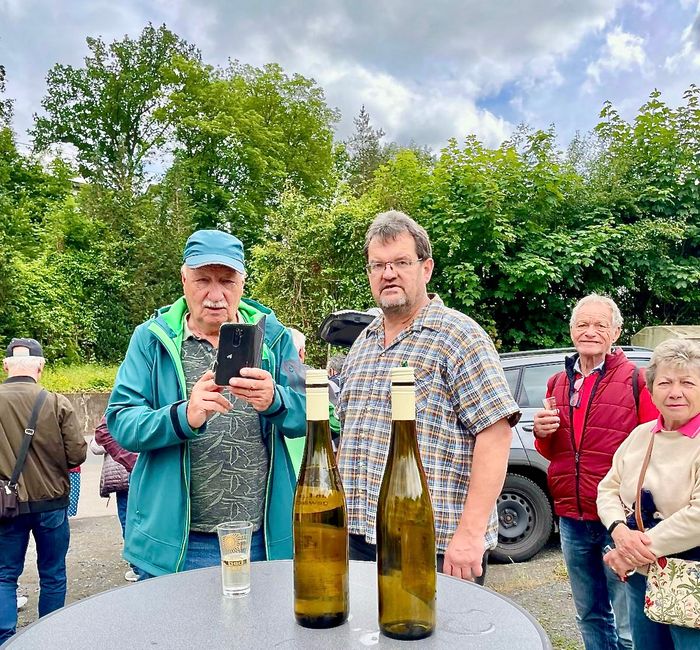 Winemaker Norbert Massengeil (centre) with tour guide Heinz, who quickly takes a photo of two wine bottles before they are gone.