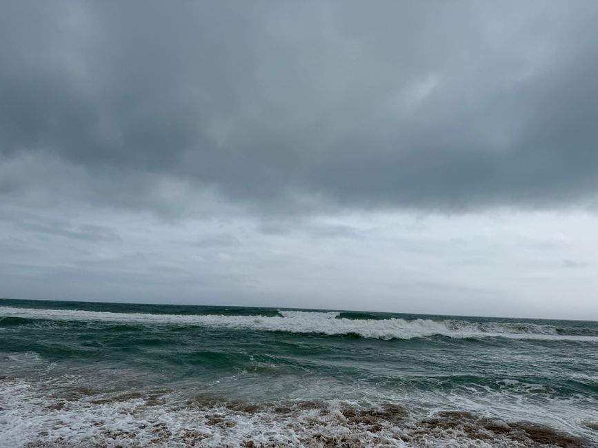 The deep gray clouds over the dark blue, almost black sea create a special atmosphere.