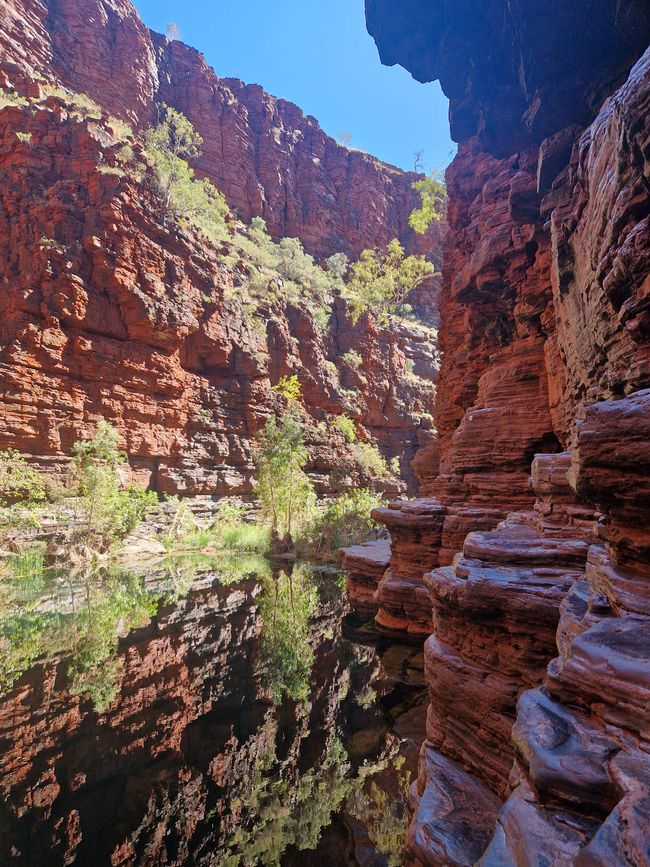 The path runs along the right side of the rocks